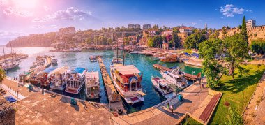 Panoramic view of the picturesque bay with marina port with yachts and cruise tourist ships near the old town of Kaleici in Antalya. Turkish Riviera and resort paradise