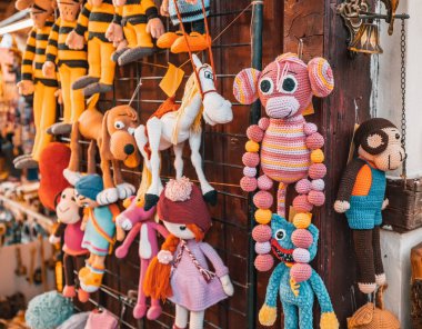 Various knitted funny toys for children are sold at the hand made market