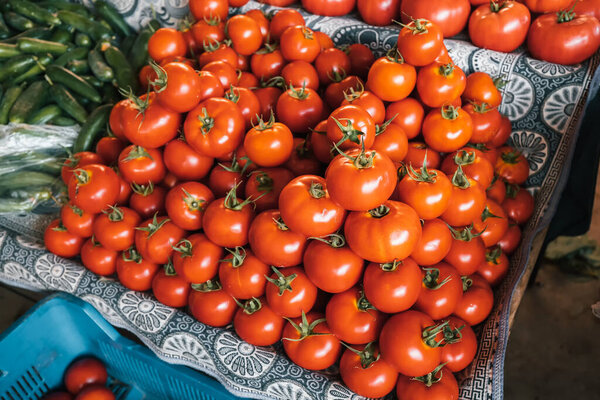 Assortment of red ripe tomatoes on the counter of the farmer's organic market in the village. Rich harvest and agricultural produce
