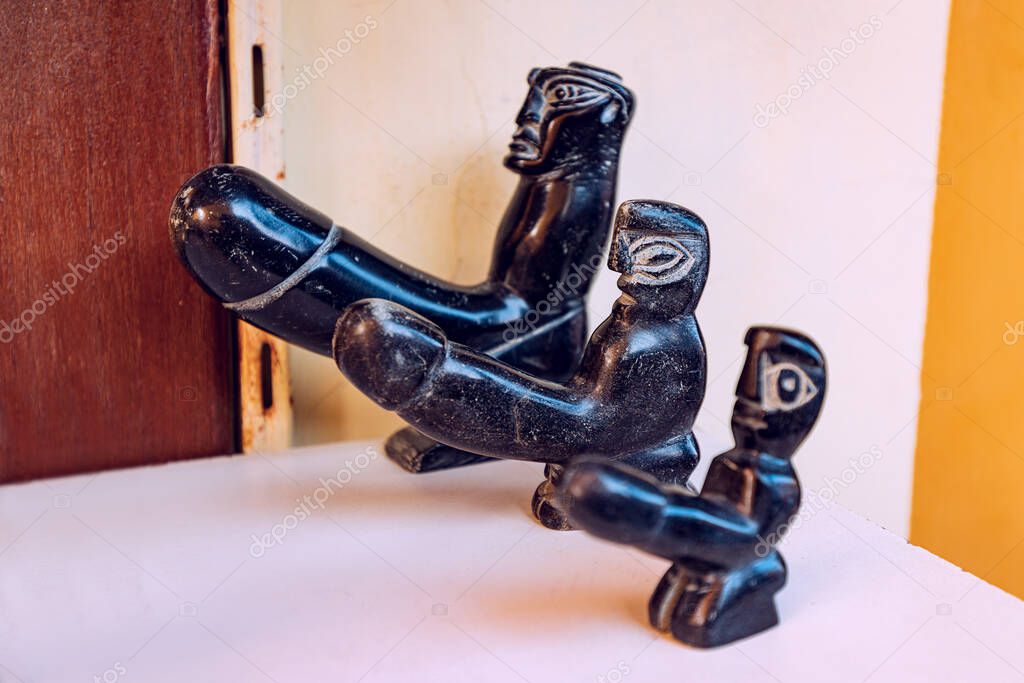 Handmade stone figurine of an ancient deity with penis. Concept of phallus and male sex power