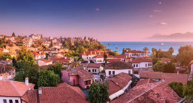 Panoramic rooftop cityscape view of Antalya resort old town and blue sea in the background