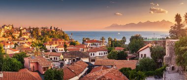 Panoramic rooftop cityscape view of Antalya resort old town and blue sea in the background