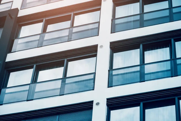 Windows and balconies on a facade of a modern residential or hotel building. Real estate and renovation and house development