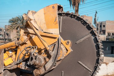 Heavy machine drum cutter and a trencher for cable laying and construction work
