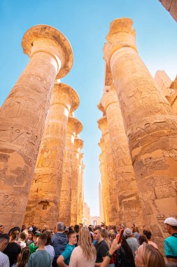 11 January 2022, Luxor, Egypt: Crowds of tourists walk through the ancient temple of Karnak among the ancient huge columns