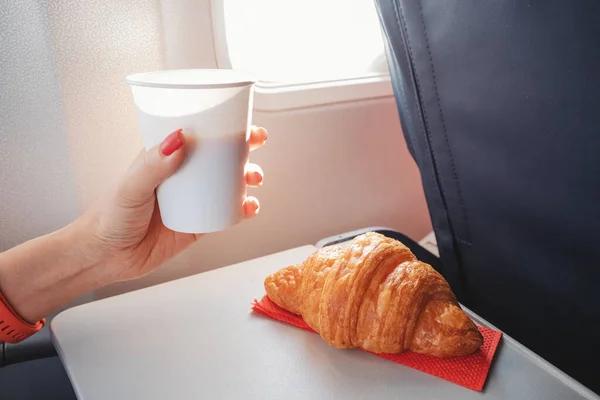 Girl Passenger Eats Croissant Drinks Coffee Sitting Window Airplane Flies — Stock Photo, Image