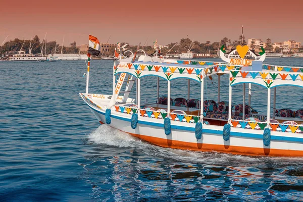 11 January 2022, Luxor, Egypt: Traditional Egyptian ferry motorboats carry passengers from one bank of the Nile to the other