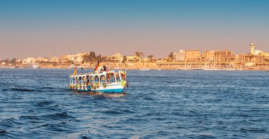 11 January 2022, Luxor, Egypt: Traditional Egyptian ferry motorboats carry passengers from one bank of the Nile to the other