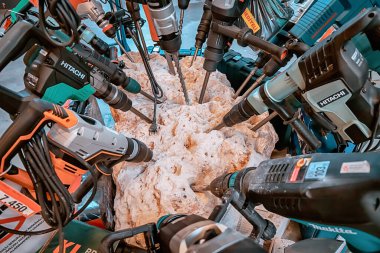 27 June 2022, Antalya, Turkey: Hitachi and Makita powerful drill tool and professional equipment grinding a rock stone in a construction department store