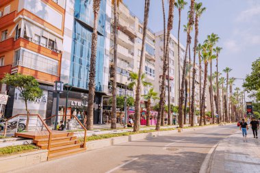 09 July 2022, Antalya, Turkey: City boulevard with automobile road and tram railroad
