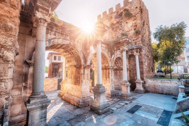 Famous gate or Hadrian arch in Antalya without visitors with sunflare. Travel landmarks and must-see tourist and sightseeing sites in Turkey