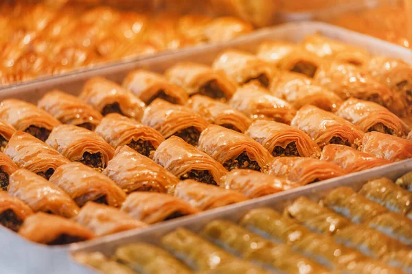 Turkish sweet baklava in the window of a traditional pastry shop in the Istanbul bazaar. It is baked from dough with sugar syrup and a filling of nuts