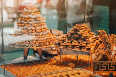 Turkish sweet baklava in the window of a traditional pastry shop in the Istanbul bazaar. It is baked from dough with sugar syrup and a filling of nuts