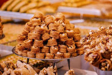 Kadayif traditional ottoman and arabic dessert with sugar noodles and nuts filling. Pastry and turkish baklava for sale