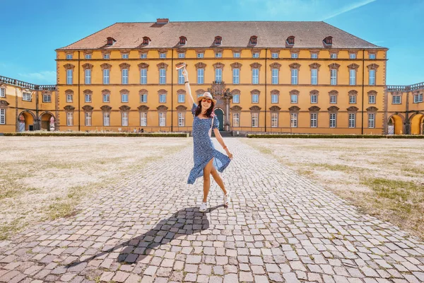 happy girl student near the campus of the old European University. Education and admission to the faculty