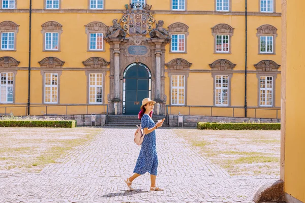 happy girl student near the campus of the old European University. Education and admission to the faculty