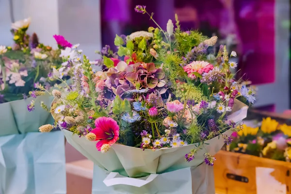 A bouquet of beautiful spring flowers is for sale in the florist shop for the holiday.