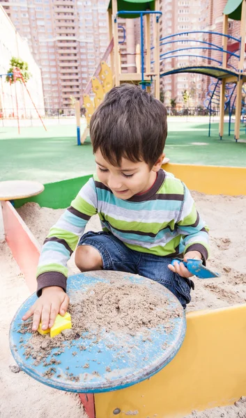 Boy playing in sandbox — Stock Photo, Image