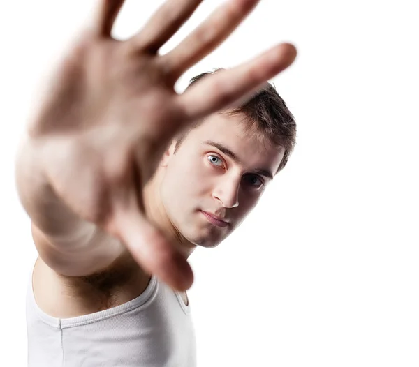 Young man looking out from under raised hand — Stock Photo, Image