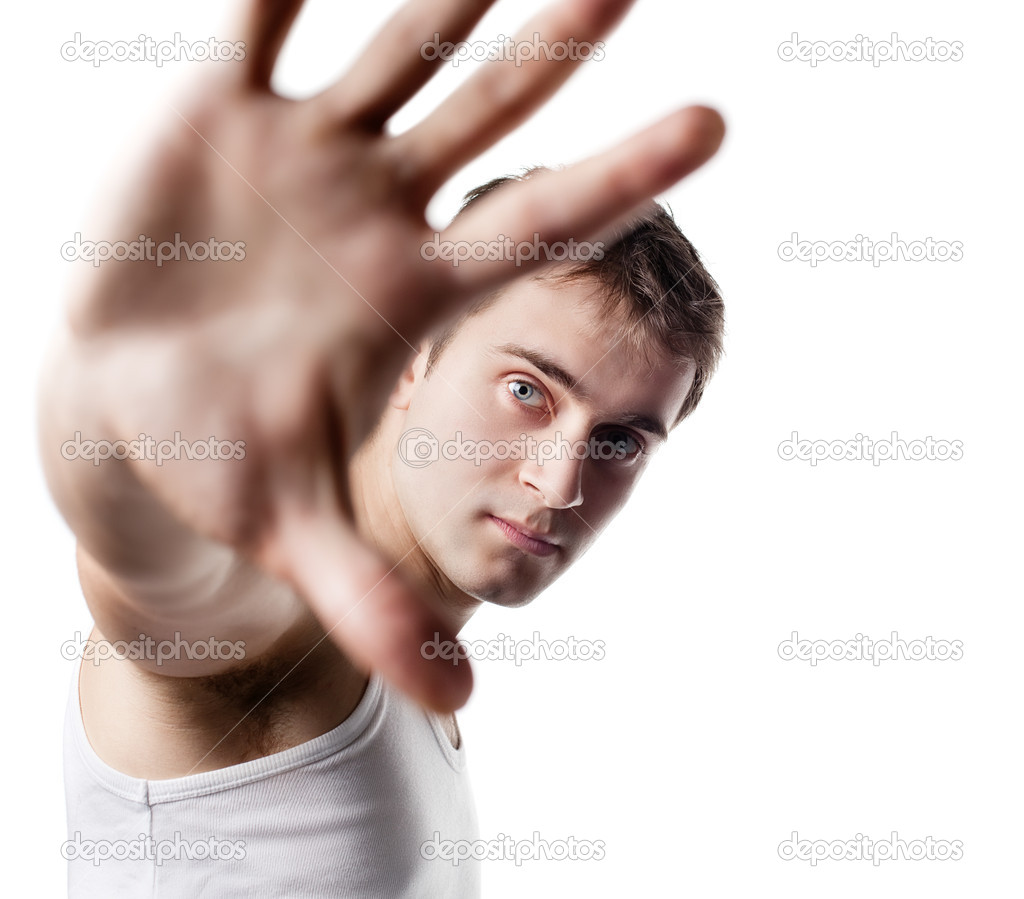 Young man looking out from under raised hand