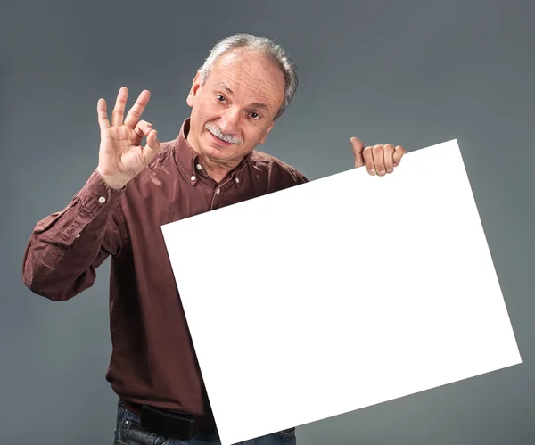 Old man holding empty billboard — Stock Photo, Image