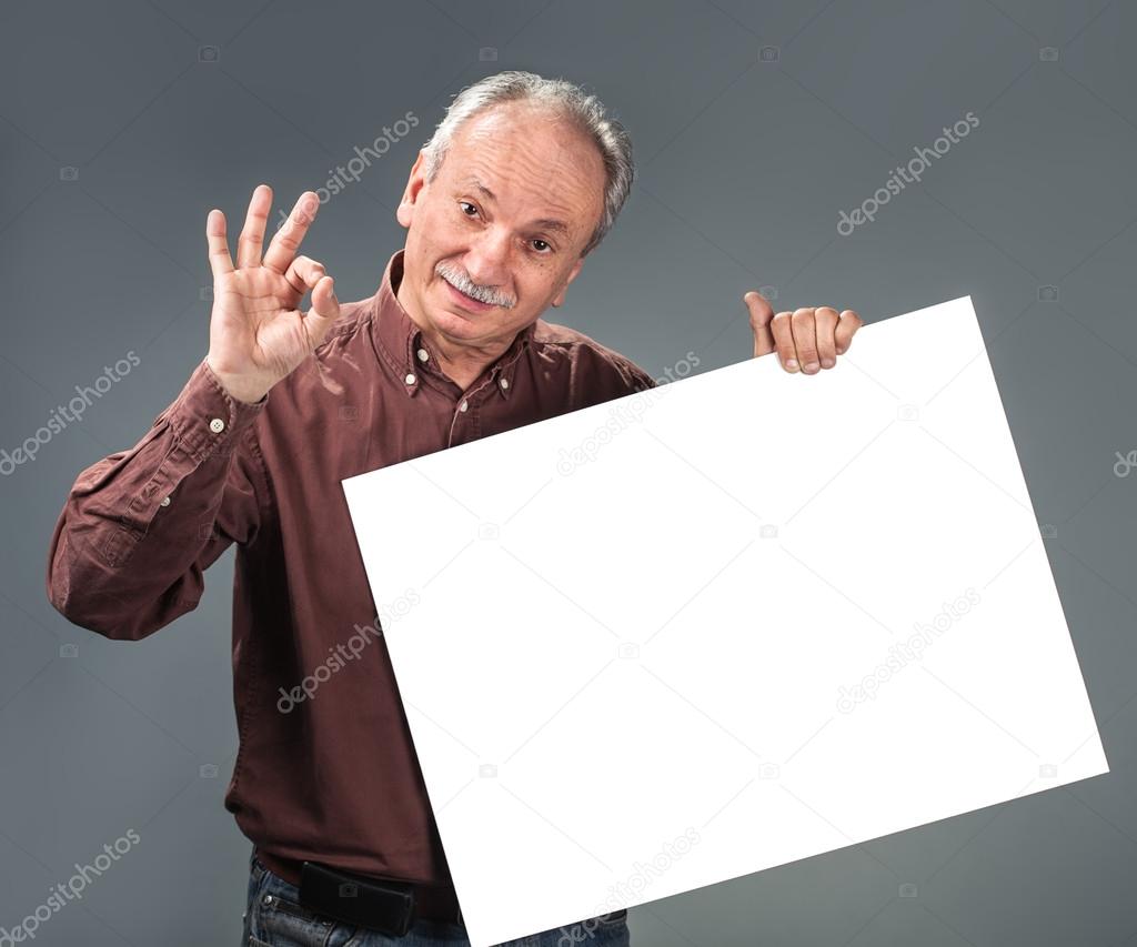 Old man holding empty billboard