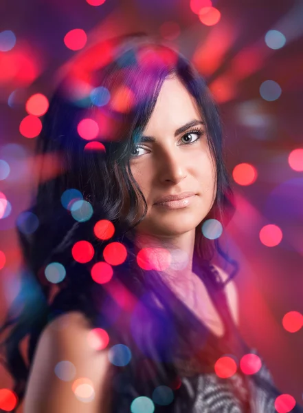 Attractive brunette girl with bokeh lights — Stock Photo, Image