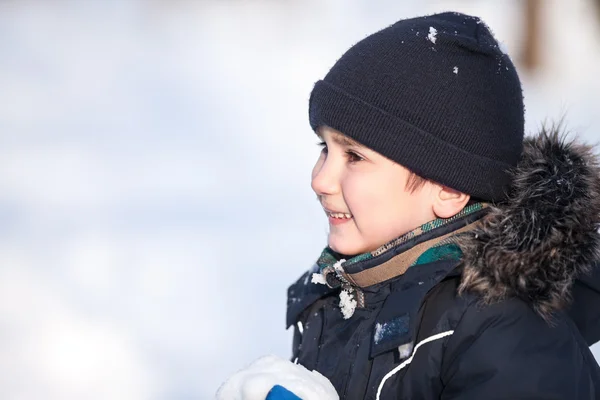 Cute boy playing with snow — Stock Photo, Image