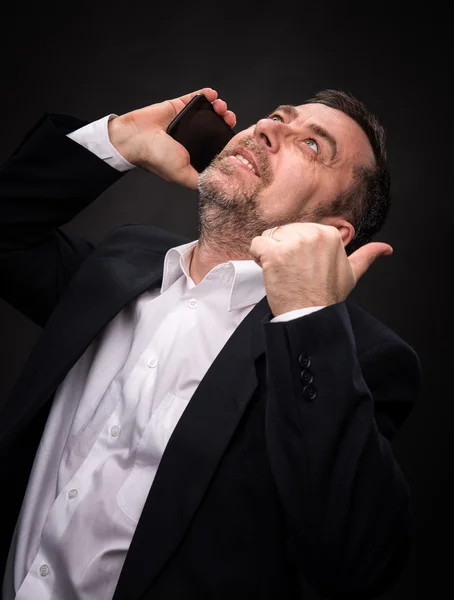 Business man speaks on a mobile phone — Stock Photo, Image