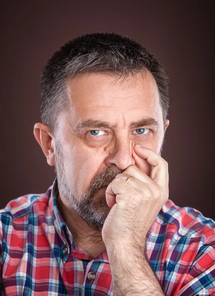 Thoughtful elderly man with hand near the face — Stock Photo, Image