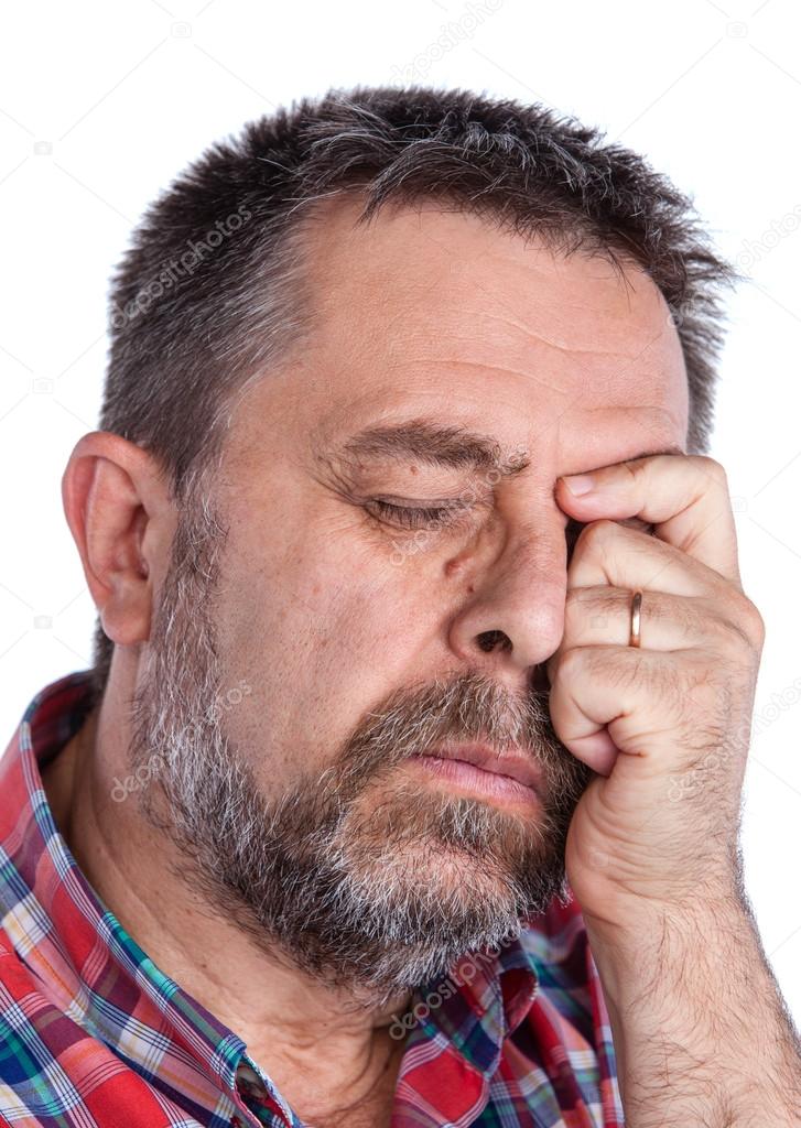 Thoughtful elderly man with hand near the face