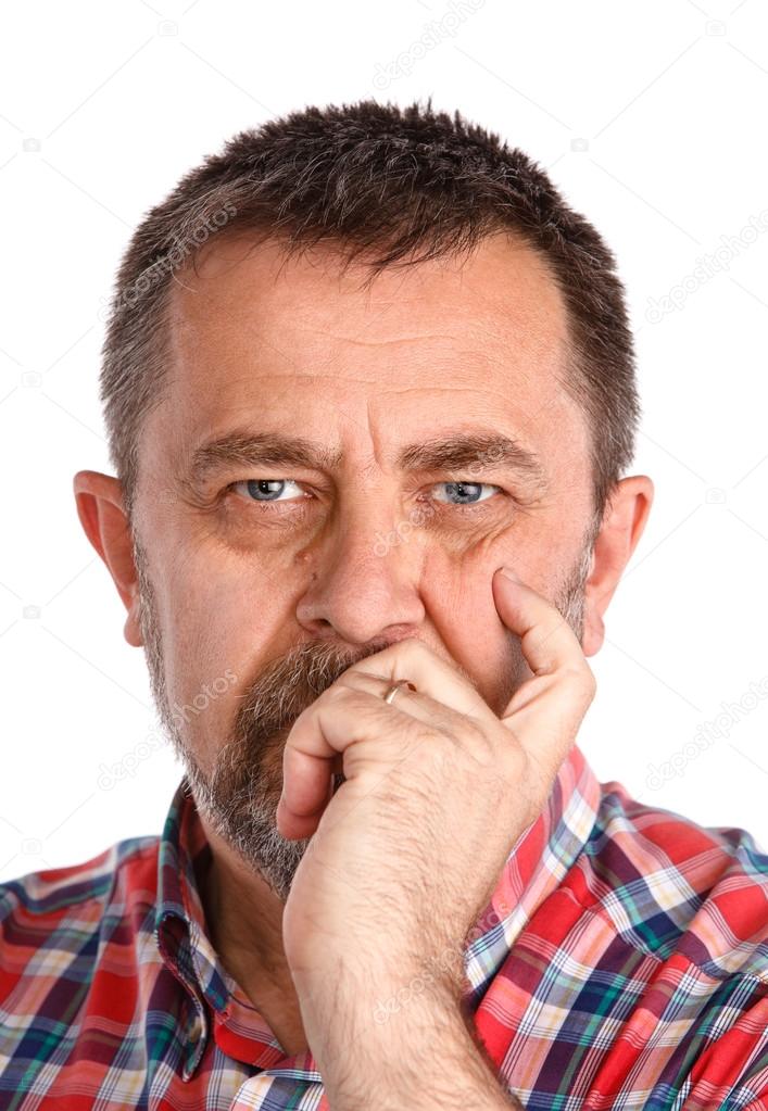 Thoughtful elderly man with hand near the face