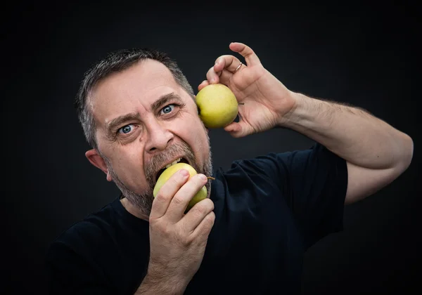 Middle-aged man with a green apples — Stock Photo, Image