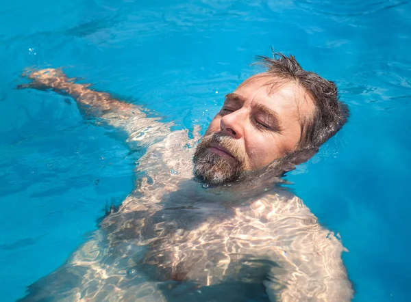 Middle-aged man in a swimming pool — Stock Photo, Image