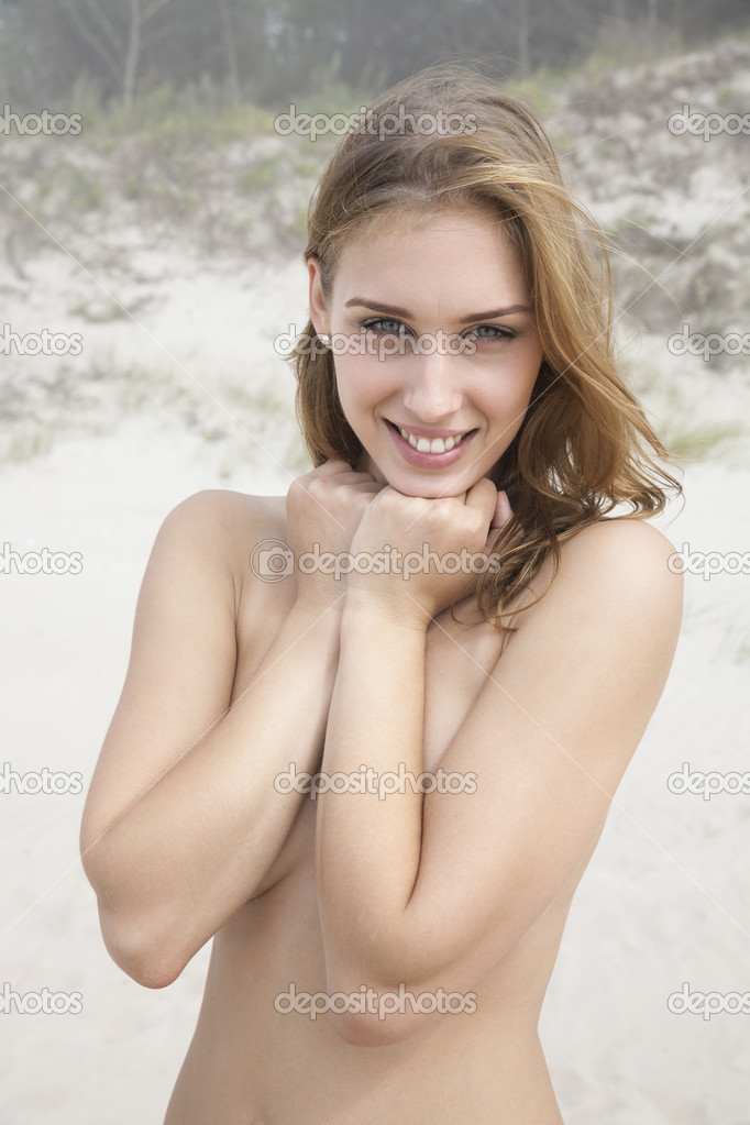 Young nude woman on sandy beach