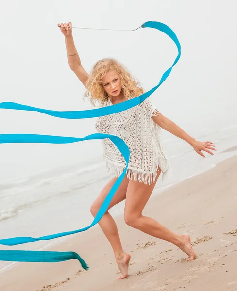 Ginasta dança com fita na praia — Fotografia de Stock