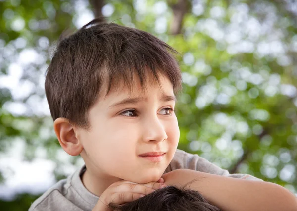 Sad little boy looking at something — Stock Photo, Image