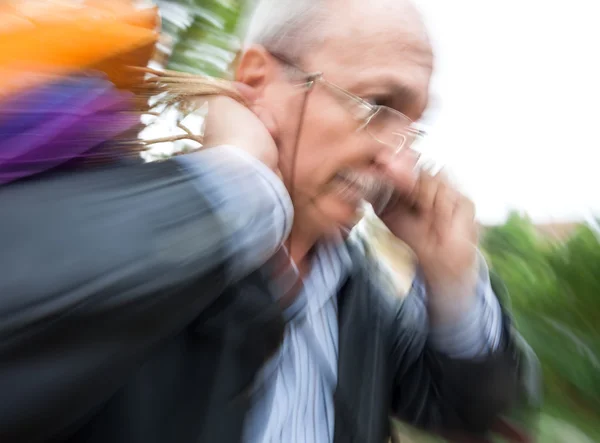 Holiday sales. An elderly man with many shopping bags in his han — Stock Photo, Image