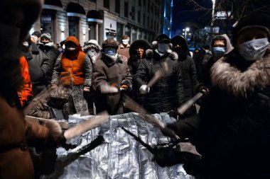 KIEV, UKRAINE - January 20, 2014: Mass anti-government protests clipart