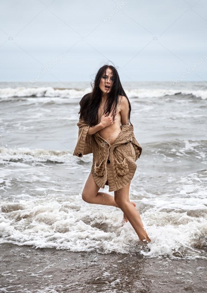 seminude woman in the cold sea waves