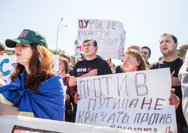 UZHGOROD, UKRAINE - MAY 1, 2014: Anti Putin demonstration in support of Ukraine's unity and termination of Russian aggression against Ukraine. Inscription on the poster: Against Putin not to scream, fight against Putin