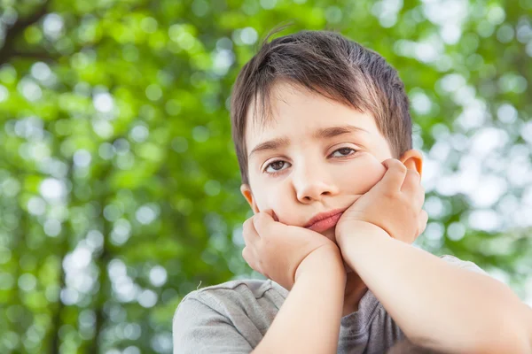 Sad little boy looking at something — Stock Photo, Image