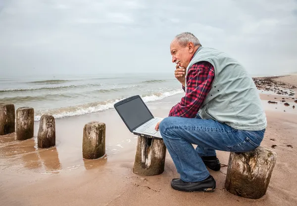 Thoughtful elderly man with the laptop — Stock Photo, Image