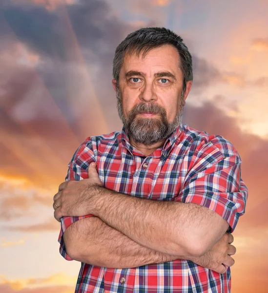 Middle-aged man on cloudy sky background — Stock Photo, Image