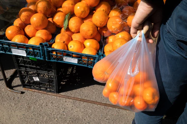 Man Bazaar Plastic Bag Tangerines Counter Oranges — Stock Photo, Image