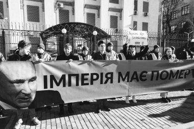 KYIV, UKRAINE - Feb. 22, 2022:  The empire must die. Protest action near the Embassy of the Russian Federation in Kiev. Text - Empire must die and Ukraine will defend clipart