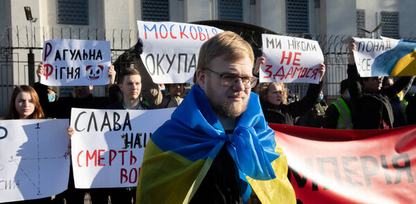 KYIV, UKRAINE - Feb. 22, 2022:  The empire must die. Protest action near the Embassy of the Russian Federation in Kiev. Text - Empire must die and Glory to the nation - death to enemies