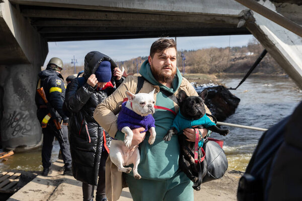 IRPIN, UKRAINE - Mar. 09, 2022: War in Ukraine. Thousands of residents of Irpin have to abandon their homes and evacuate as russian troops are bombing a peaceful city. War refugees in Ukraine