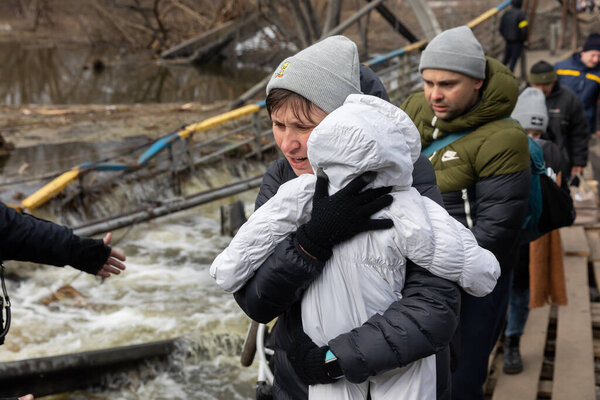 IRPIN, UKRAINE - Mar. 09, 2022: War in Ukraine. Thousands of residents of Irpin have to abandon their homes and evacuate as russian troops are bombing a peaceful city. War refugees in Ukraine