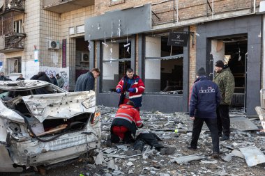 KYIV, UKRAINE - Mar. 14, 2022: Ukrayna 'ya karşı Rusya Savaşı. Öldürülen sivil, Kyiv şehrine yapılan roketatarla hasar gören sivil evin önündeki kaldırımda yatıyor.
